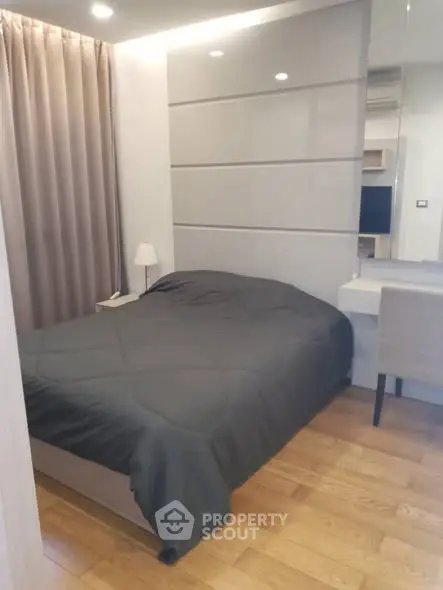 Cozy modern bedroom with wooden flooring and sleek design