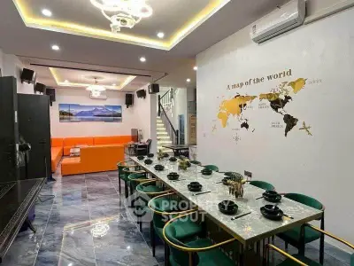 Luxurious dining and living area with modern decor and world map wall art, perfect for entertaining.