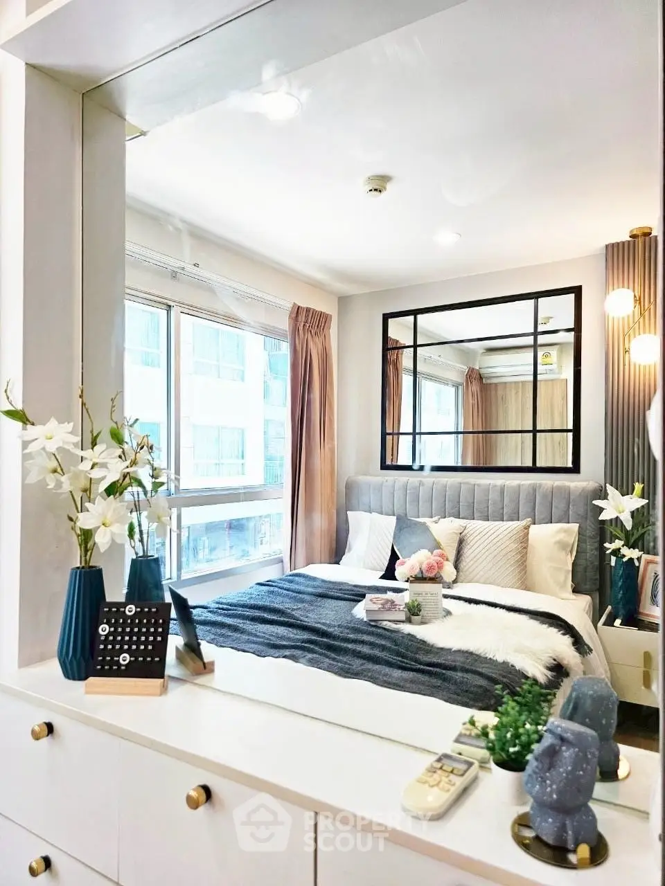Chic and cozy bedroom with modern decor and large window for natural light.