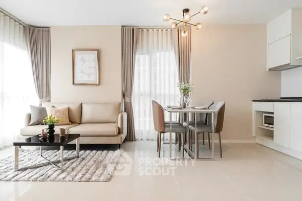 Modern open-plan living room with elegant dining area and stylish kitchen in a bright apartment.