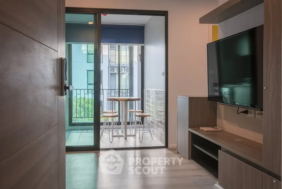 Modern apartment interior with balcony view and sleek furniture design.