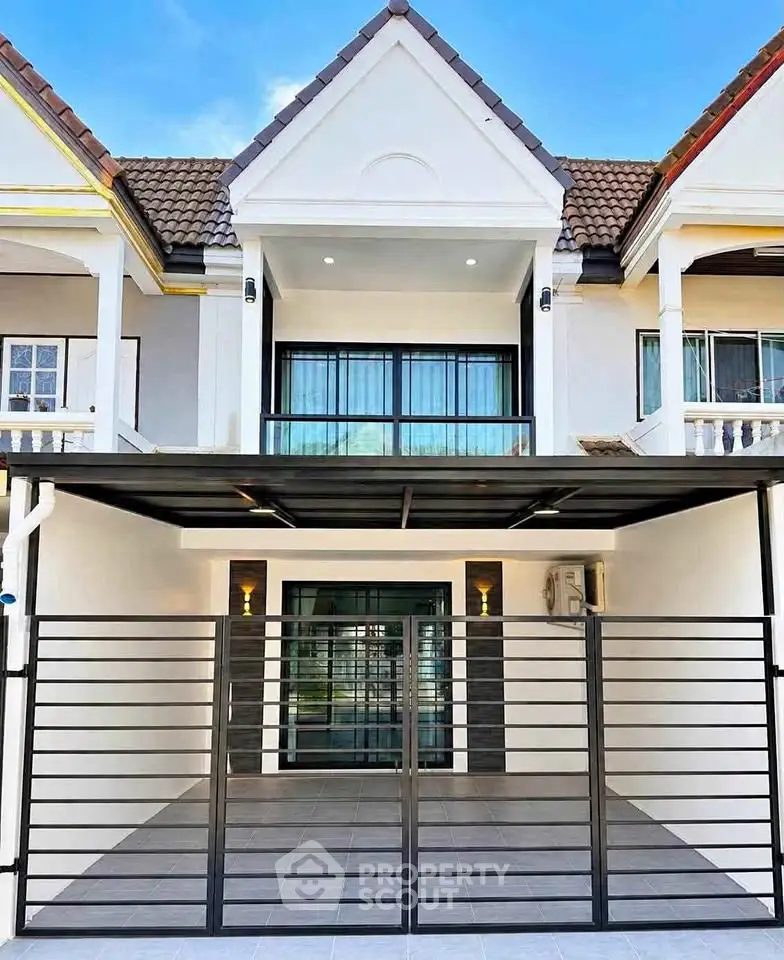 Charming townhouse with modern facade and spacious gated driveway, perfect for family living.