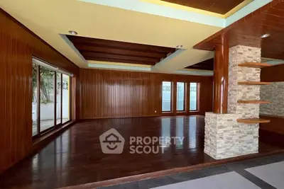 Spacious wooden living room with large windows and modern design