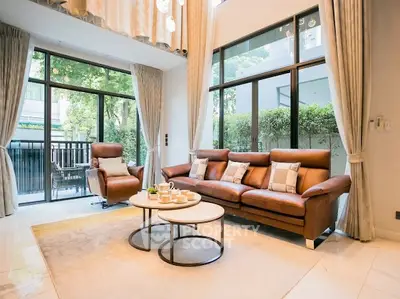 Luxurious living room with floor-to-ceiling windows and elegant furnishings