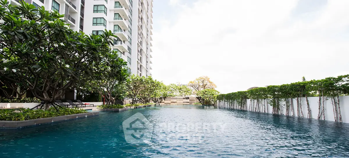 Luxurious condominium with stunning pool and lush greenery