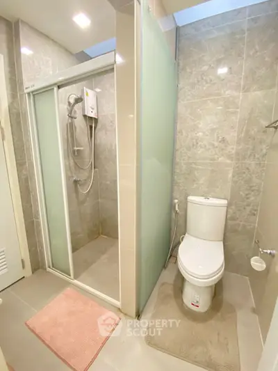 Modern bathroom with glass shower and sleek toilet design