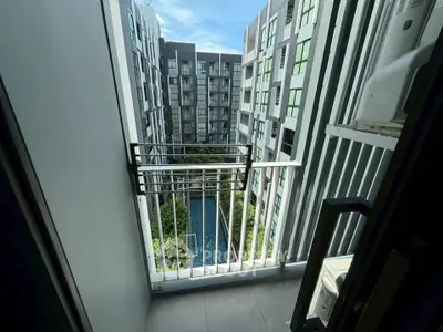 Modern apartment balcony with pool view in urban setting