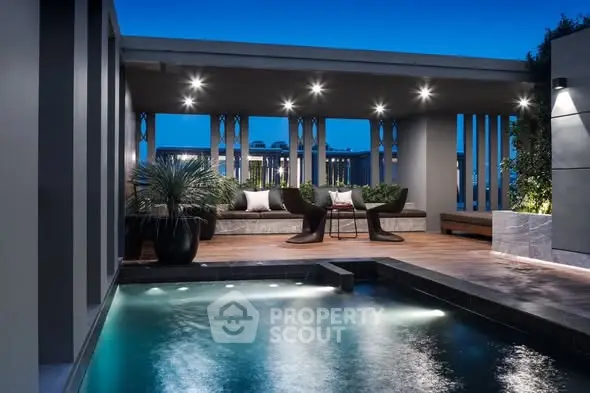 Luxurious rooftop pool area with modern seating and ambient lighting at dusk.