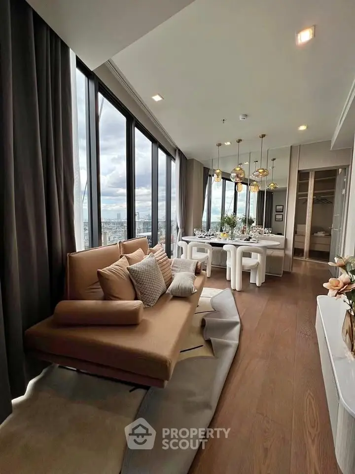 Luxurious high-rise living room with panoramic city views and elegant dining area.