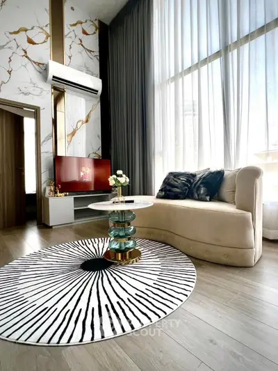 Luxurious living room with high ceilings, elegant decor, and large windows for natural light.