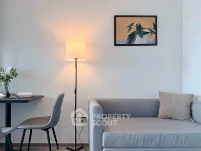 Modern living room with stylish gray sofa and elegant floor lamp, perfect for cozy evenings.