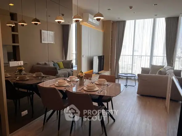 Luxurious modern living room with dining area, featuring elegant decor and large windows with city views.