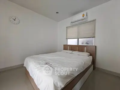 Modern minimalist bedroom with air conditioning and stylish bed