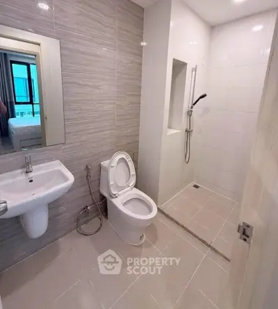 Modern bathroom with sleek design and walk-in shower in a contemporary apartment.