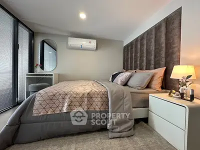 Modern bedroom with stylish decor and cozy ambiance, featuring a comfortable bed and elegant furnishings.