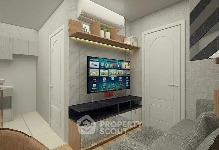 Modern living room with wall-mounted TV and stylish decor in a cozy apartment.