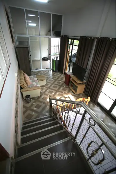 Spacious living room with modern decor and large windows for natural light