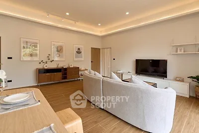 Spacious modern living room with elegant decor and large TV