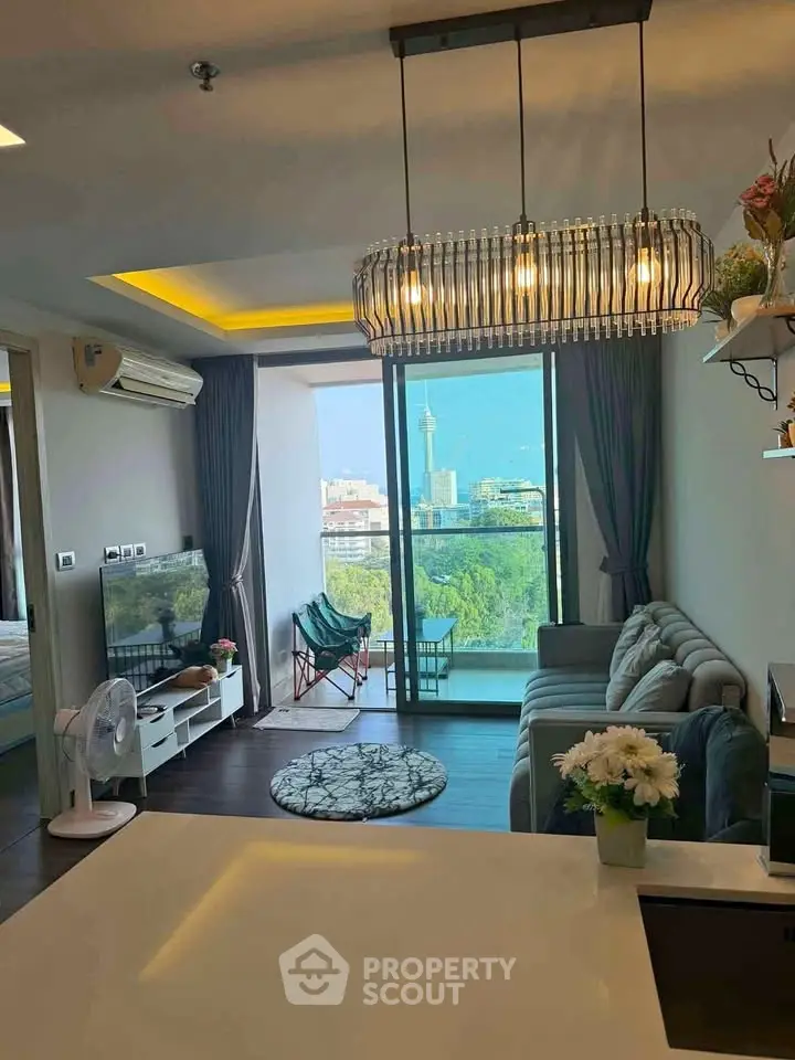 Modern living room with city view, stylish lighting, and cozy seating area in a high-rise apartment.