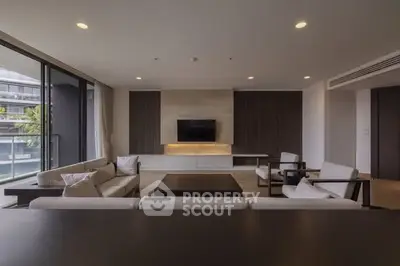 Luxurious modern living room with elegant furniture and large windows offering a stunning view.