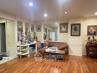 Spacious living room with wooden flooring and decorative art pieces
