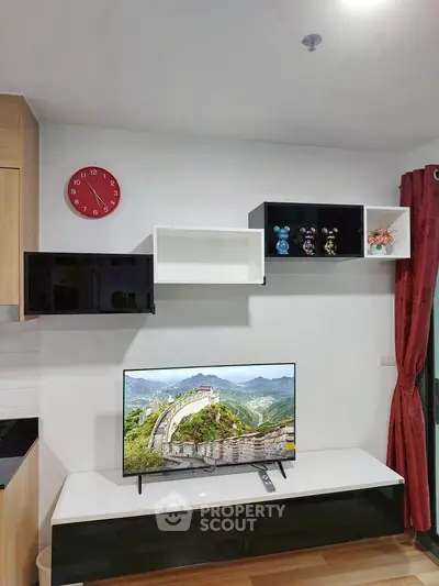 Modern living room with wall-mounted TV and stylish shelving