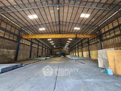 Spacious industrial warehouse with high ceilings and ample storage space.