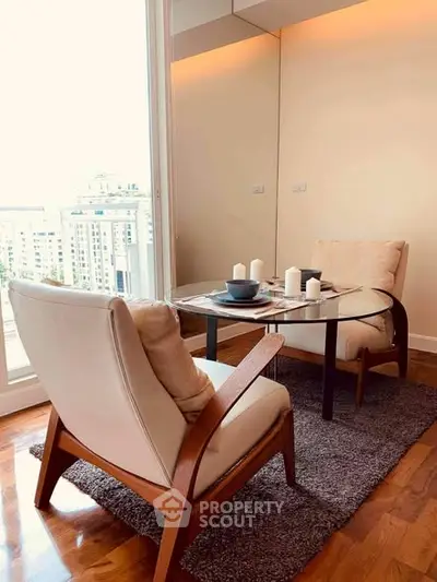Elegant living room with cozy seating and city view, perfect for relaxation and entertaining.