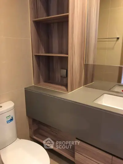 Modern bathroom with sleek wooden cabinetry and dual sinks