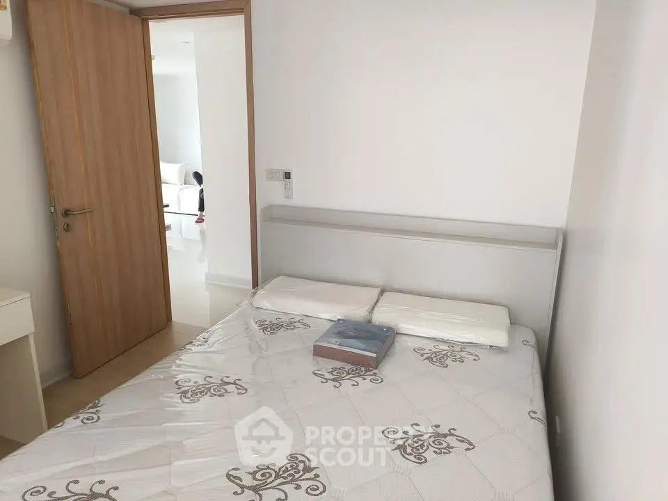 Cozy bedroom with modern decor and natural light, perfect for relaxation and comfort.