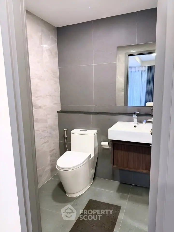 Modern bathroom with sleek design and contemporary fixtures in a stylish apartment.