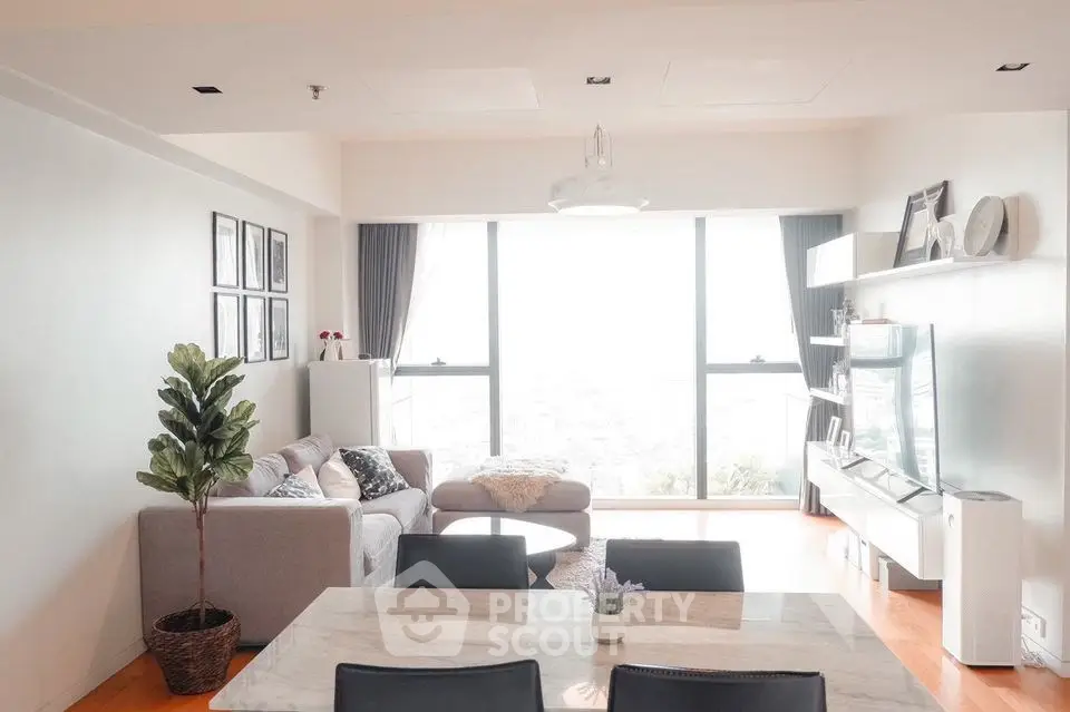 Spacious modern living room with large windows and stylish decor