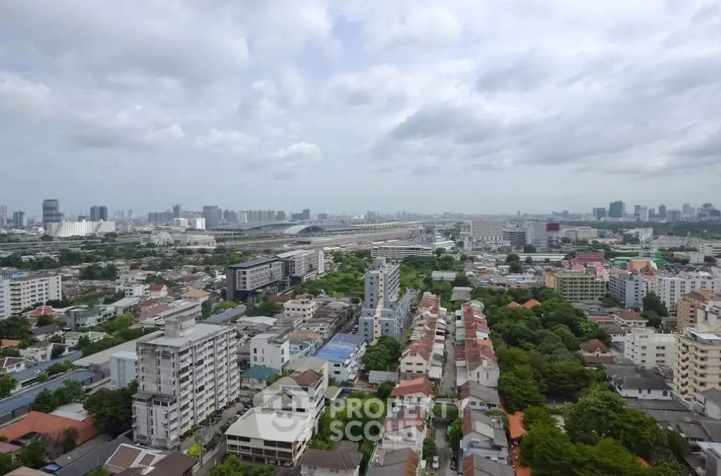 Stunning cityscape view showcasing urban skyline and residential buildings under a cloudy sky.