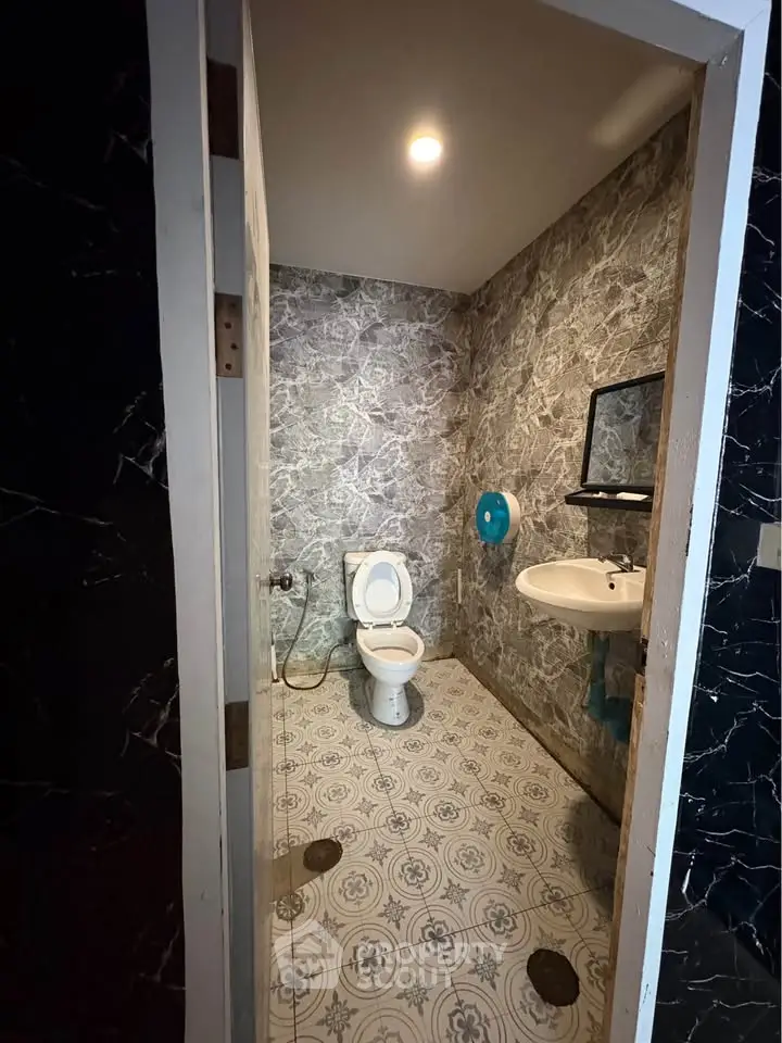 Stylish bathroom with modern marble walls and patterned floor tiles