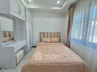 Cozy bedroom with elegant decor and ample natural light