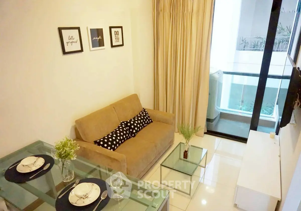 Cozy living room with modern decor and balcony view in a stylish apartment.