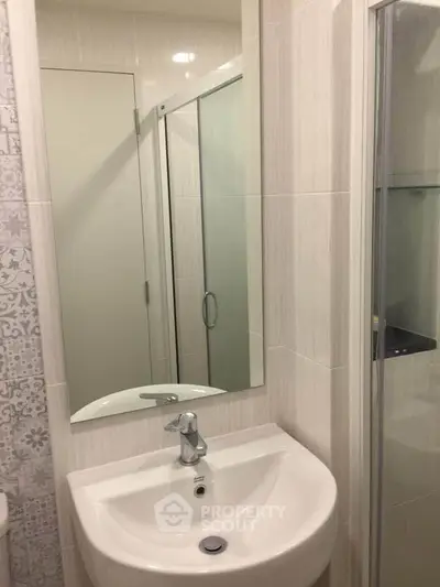 Modern bathroom with sleek sink and glass shower enclosure