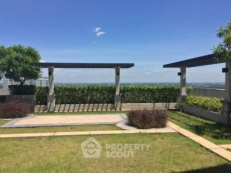 Stunning rooftop garden with panoramic city views and lush greenery.