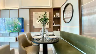 Modern dining area with stylish decor and wall-mounted TV in a contemporary apartment.