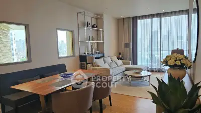 Luxurious modern living room with city view, elegant decor, and spacious seating area.
