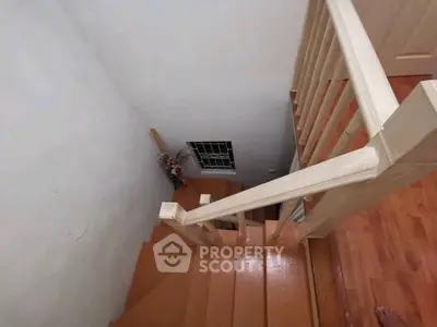 Charming wooden staircase with decorative railing in cozy home interior