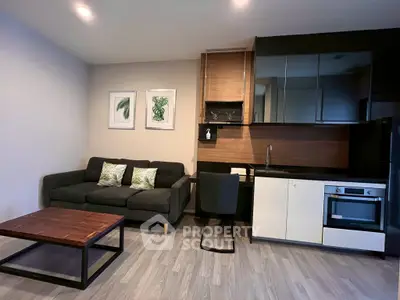 Modern living room with sleek kitchen and stylish decor