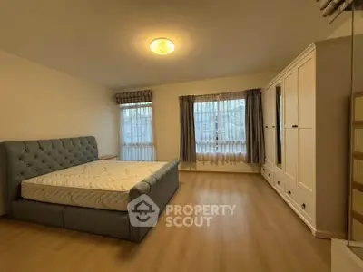 Spacious bedroom with elegant bed and ample natural light