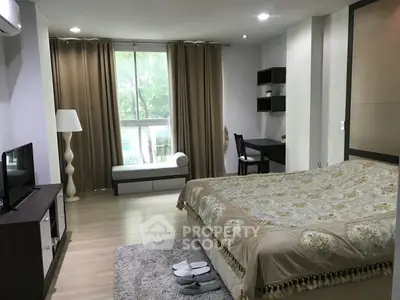 Spacious bedroom with elegant decor and large window view