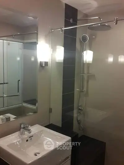 Modern bathroom with sleek fixtures and glass shower enclosure