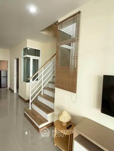 Modern interior with sleek staircase and stylish decor in a contemporary home.