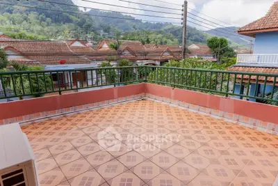 Spacious tiled balcony with scenic mountain views and charming neighborhood.