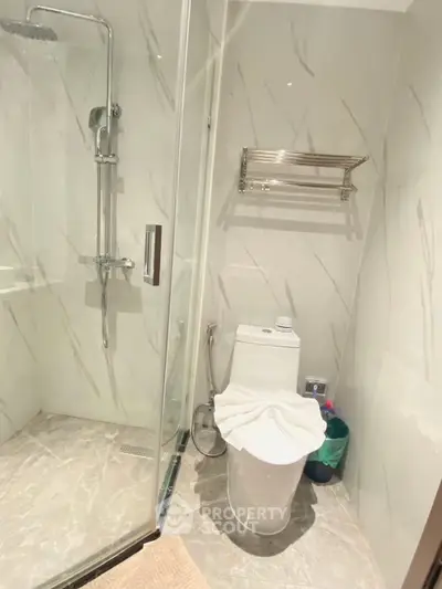 Modern bathroom with glass shower and sleek marble tiles
