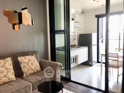 Modern apartment with stylish living room and sleek kitchen featuring open layout and natural light.