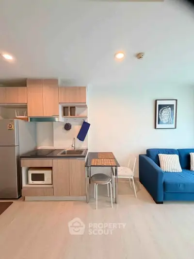 Modern open-layout kitchen with cozy living area and stylish decor
